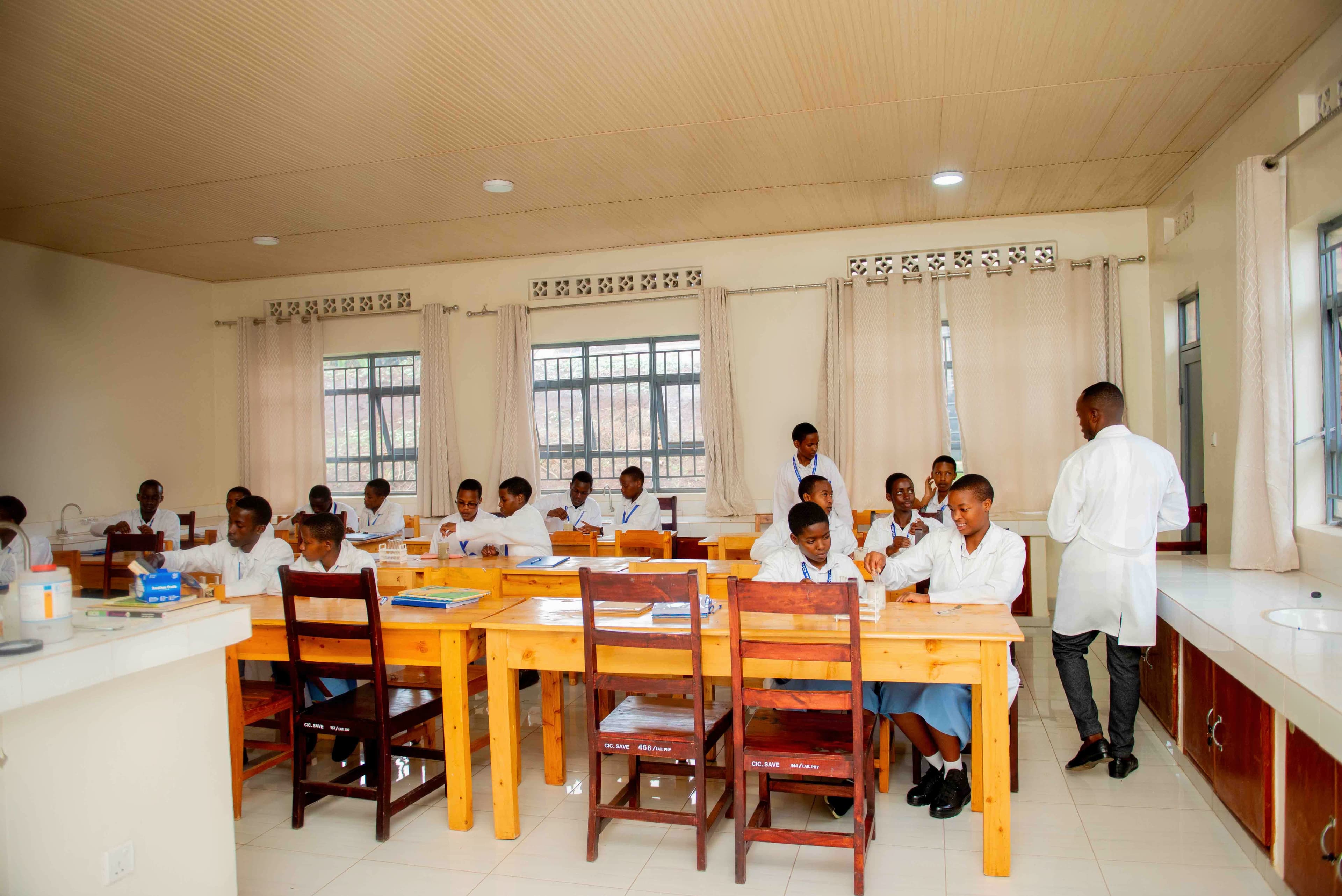 Students in lab coats mixing chemicals or presenting eco-fashion prototypes.